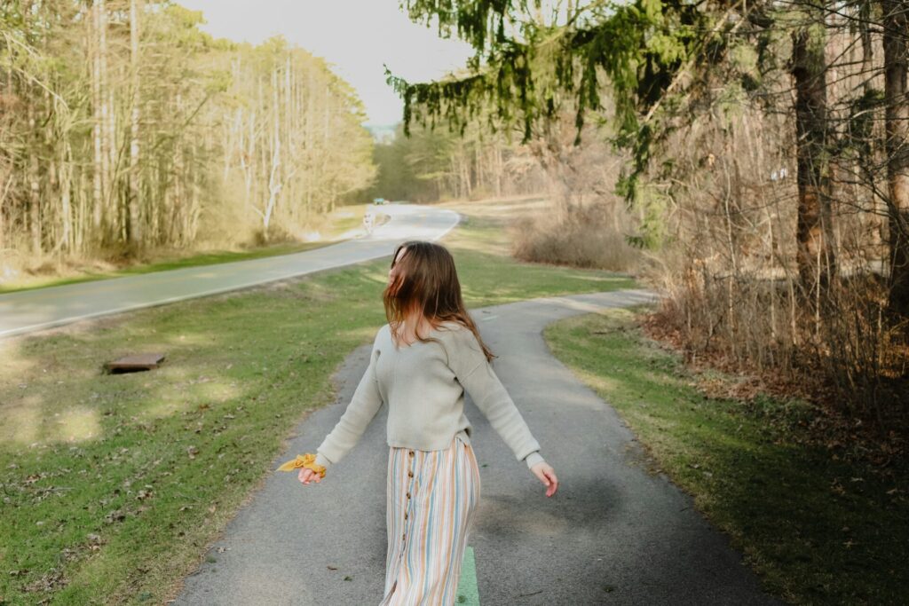 Woman enjoying nature, symbolizing financial independence and semi-retirement through frugal living and passive income investing.